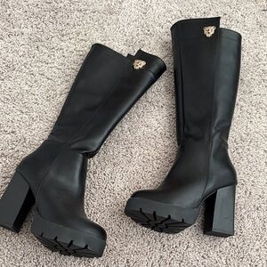 Chic Black Heeled Boots with Gold Accent